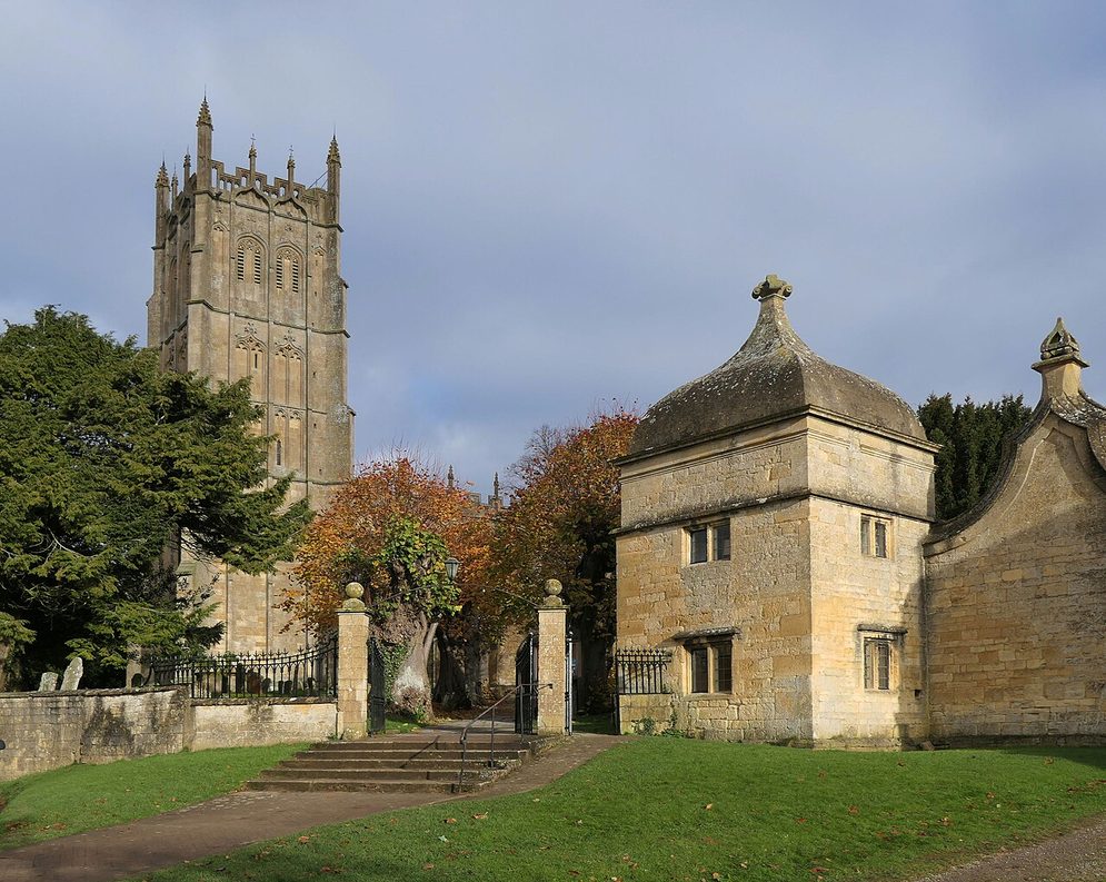 The gateway and lodges of Old Campden House, with ogee-capped roofs, beside the church in Chipping Campden
