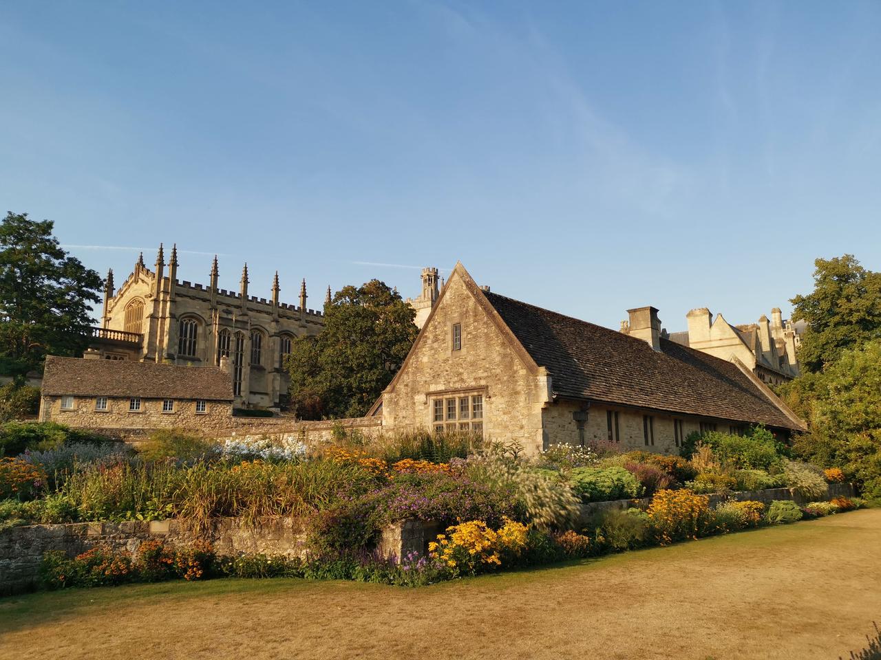 Christ Church Cathedral in Oxford seen above the college buildings and a flower garden