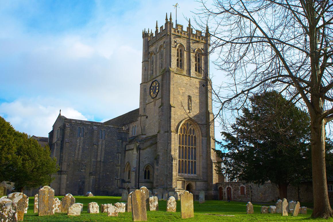 Christchurch Priory and its tall Perpendicular west tower above the churchyard