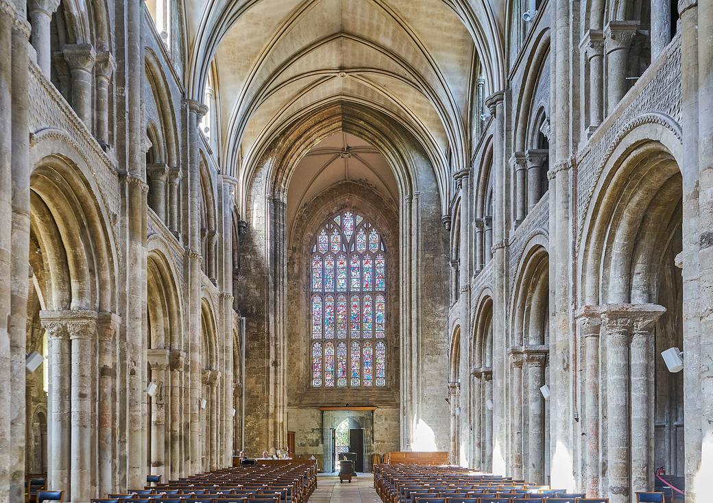 The nave of Christchurch Priory with round Norman arches and a later vault