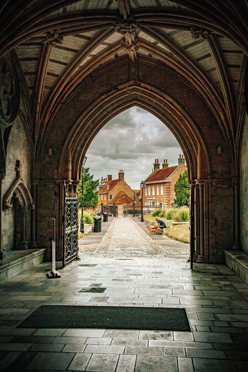 Looking out through the vaulted north porch of Christchurch Priory to the town