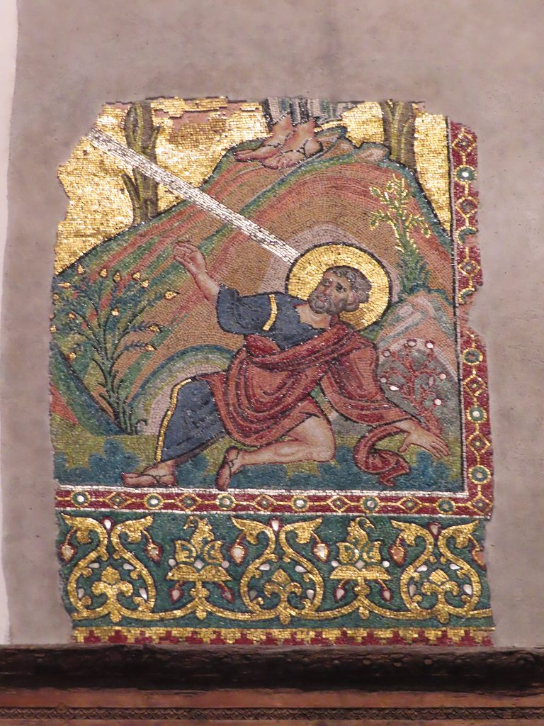 A restored twelfth-century mosaic of an angel in gold and red on the nave wall of the Church of the Nativity