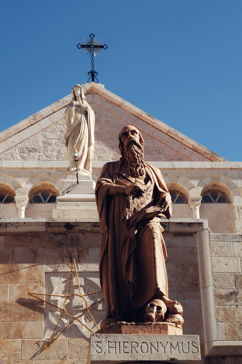 A bronze statue of St Jerome on a column in the cloister of St Catherine's, Bethlehem