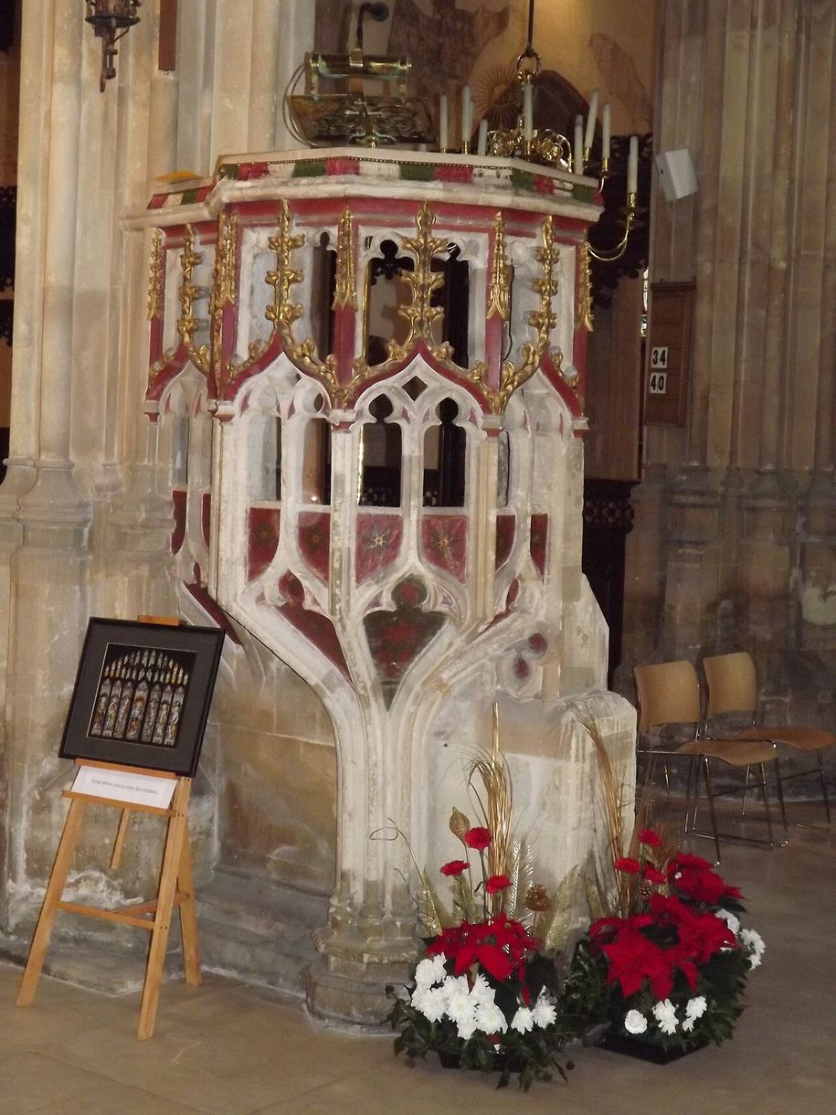 The medieval stone wine-glass pulpit of Cirencester church, painted and carved with tracery