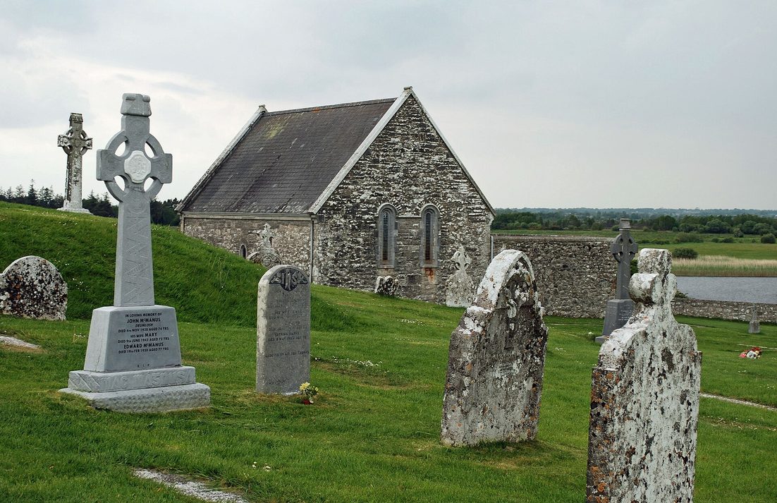 Temple Connor at Clonmacnoise, a small roofed stone church with a slate roof, beside the graveyard