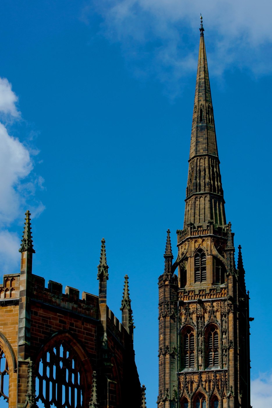 The tower and spire of the old Coventry Cathedral rising above the ruined walls