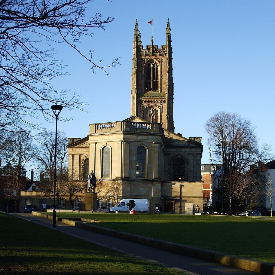 Derby Cathedral, its tall Perpendicular Gothic tower with pinnacles rising beside the classical Georgian nave, among trees