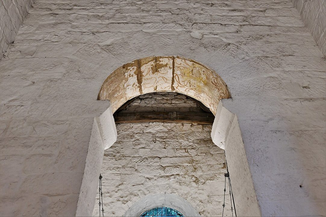 The tall round chancel arch at Escomb, built of large dressed stones laid in long-and-short fashion