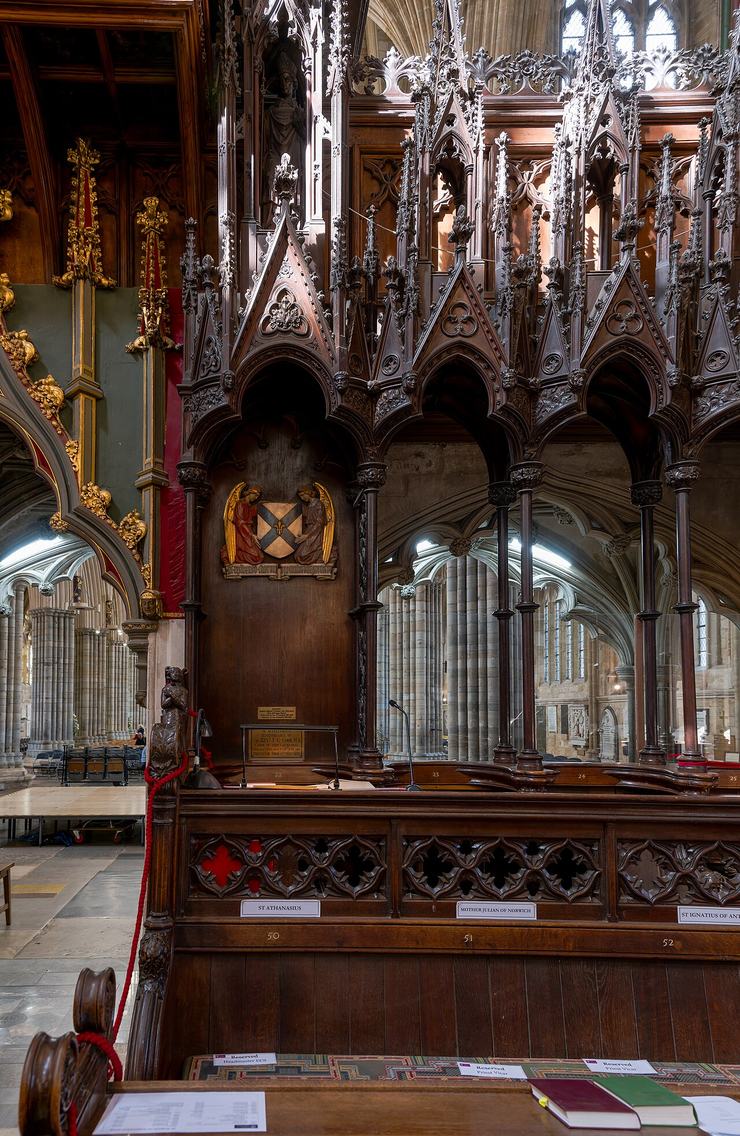 The tall carved oak canopy of the bishop's throne in the choir of Exeter Cathedral