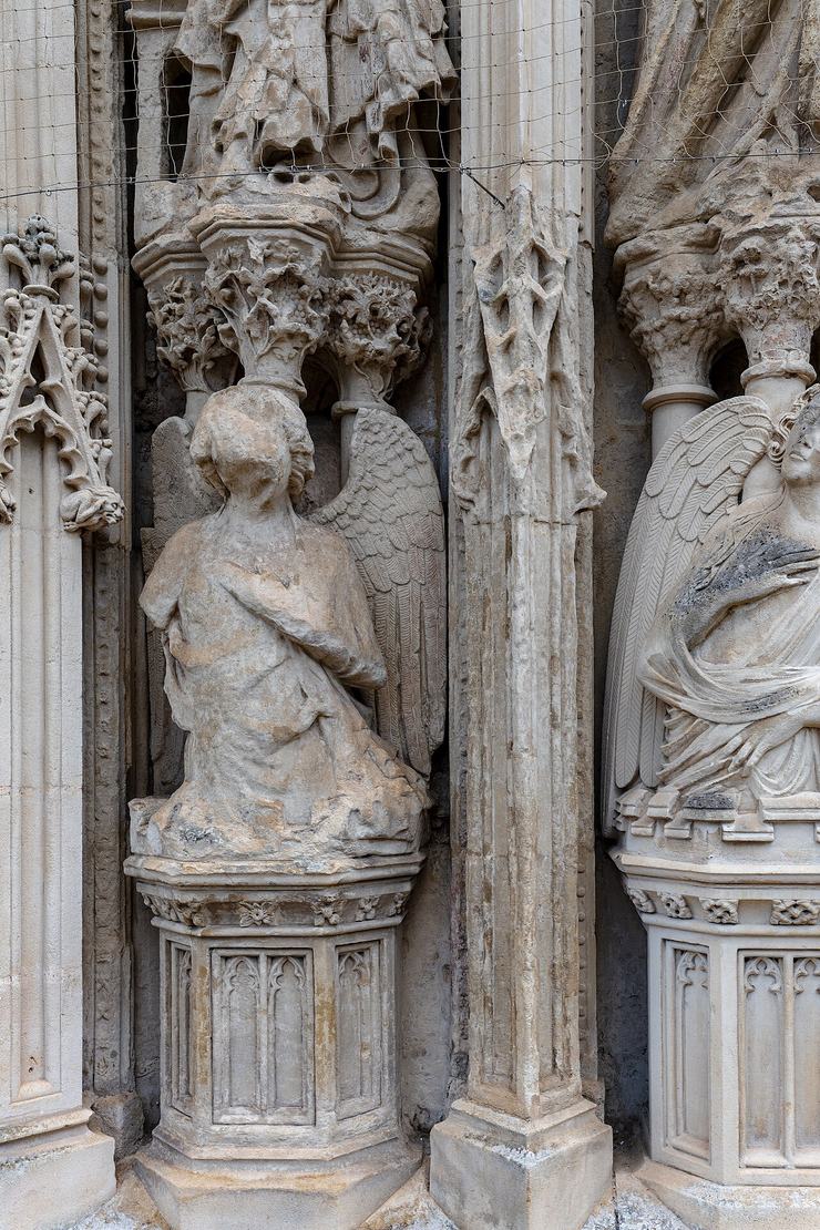 Weathered carved figures in the image screen on the west front of Exeter Cathedral