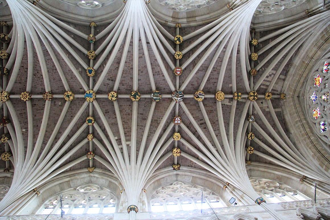 Looking straight up at the palm-tree ribs and painted bosses of the vault at Exeter Cathedral