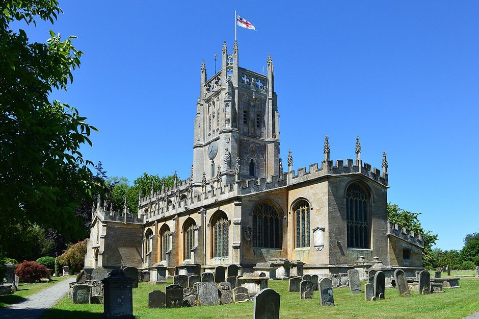 St Mary's Church, Fairford, Gloucestershire, a Perpendicular Cotswold wool church with a pinnacled central tower, seen across the churchyard