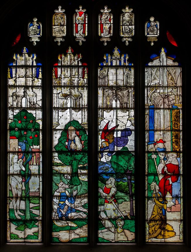 Medieval stained glass at Fairford showing Adam and Eve and the serpent in the Garden of Eden