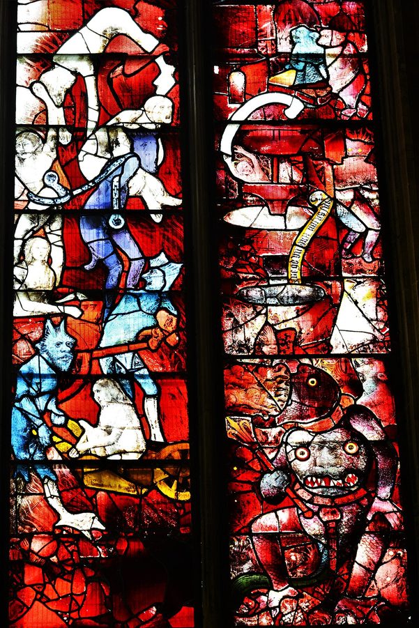 Detail of the Last Judgement window at Fairford, with red and blue devils dragging souls into hell