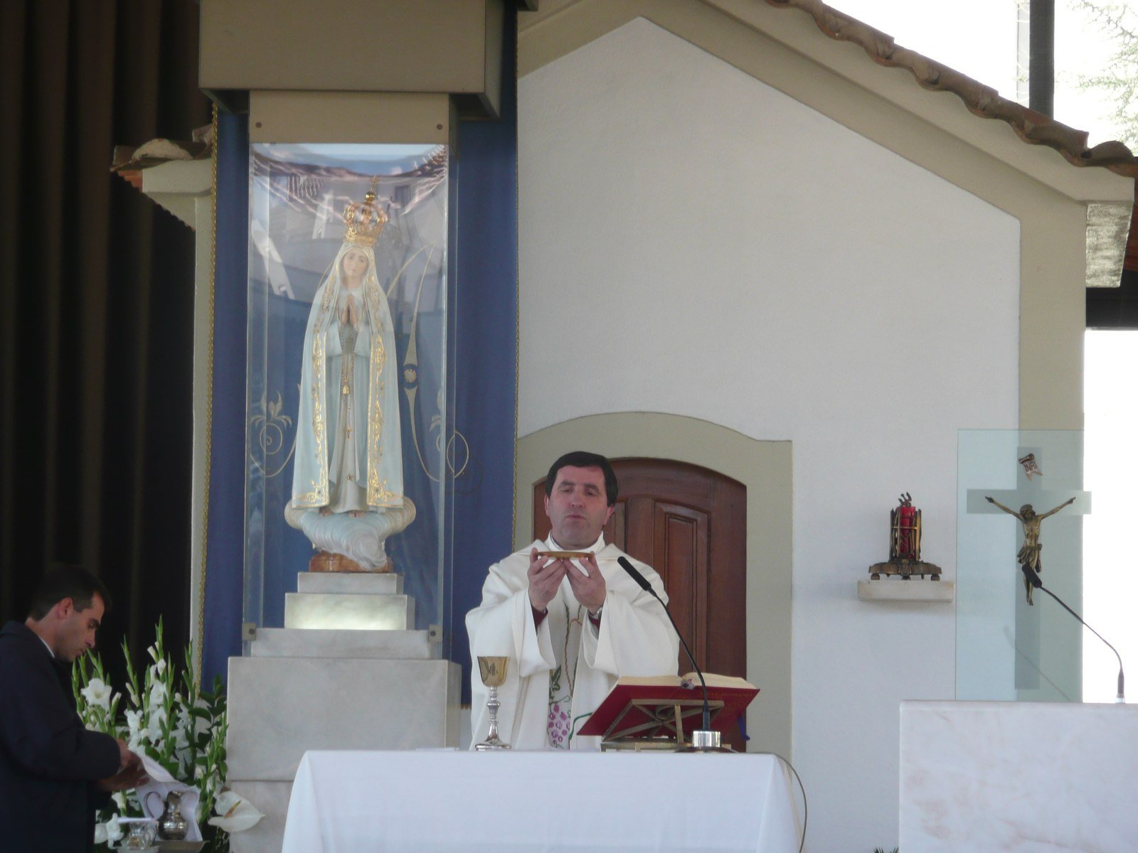 Mass being celebrated at the Chapel of the Apparitions with the statue of Our Lady in her niche