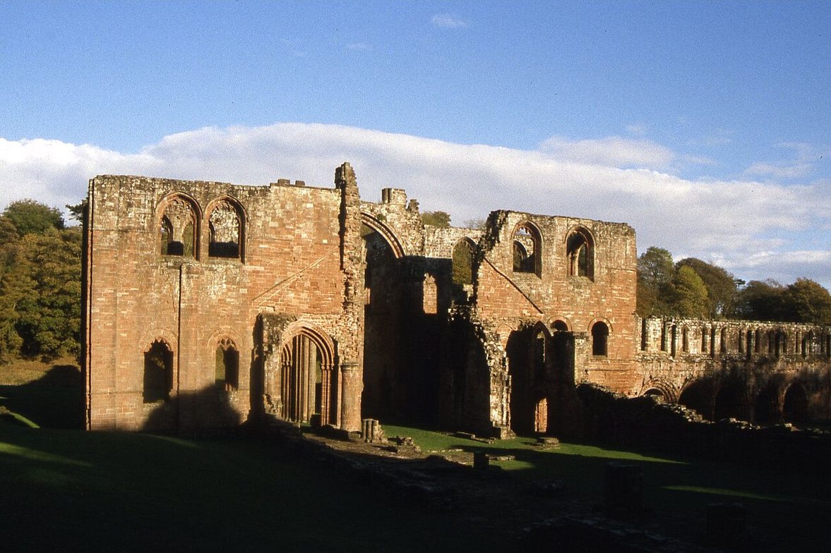 Late afternoon sun on the ruins of Furness Abbey, with the east end and transepts glowing red