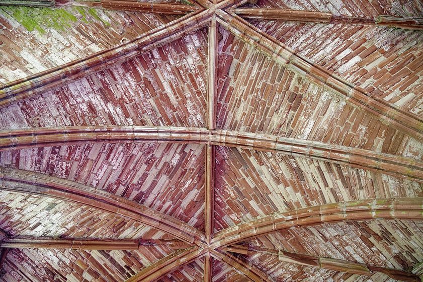 The stone vault of the infirmary chapel at Furness Abbey, its ribs meeting at a central boss