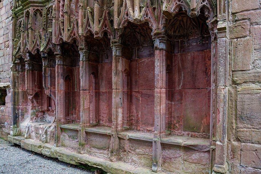 The carved stone canopied seats of the sedilia in the presbytery of Furness Abbey, in red sandstone