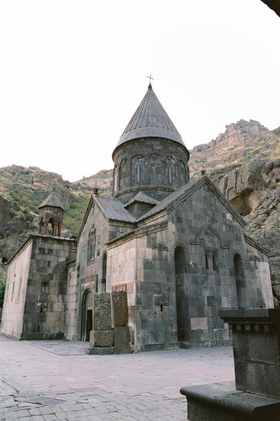 Geghard Monastery, its stone chapels built directly into the cliff face of the Azat Gorge, Armenia
