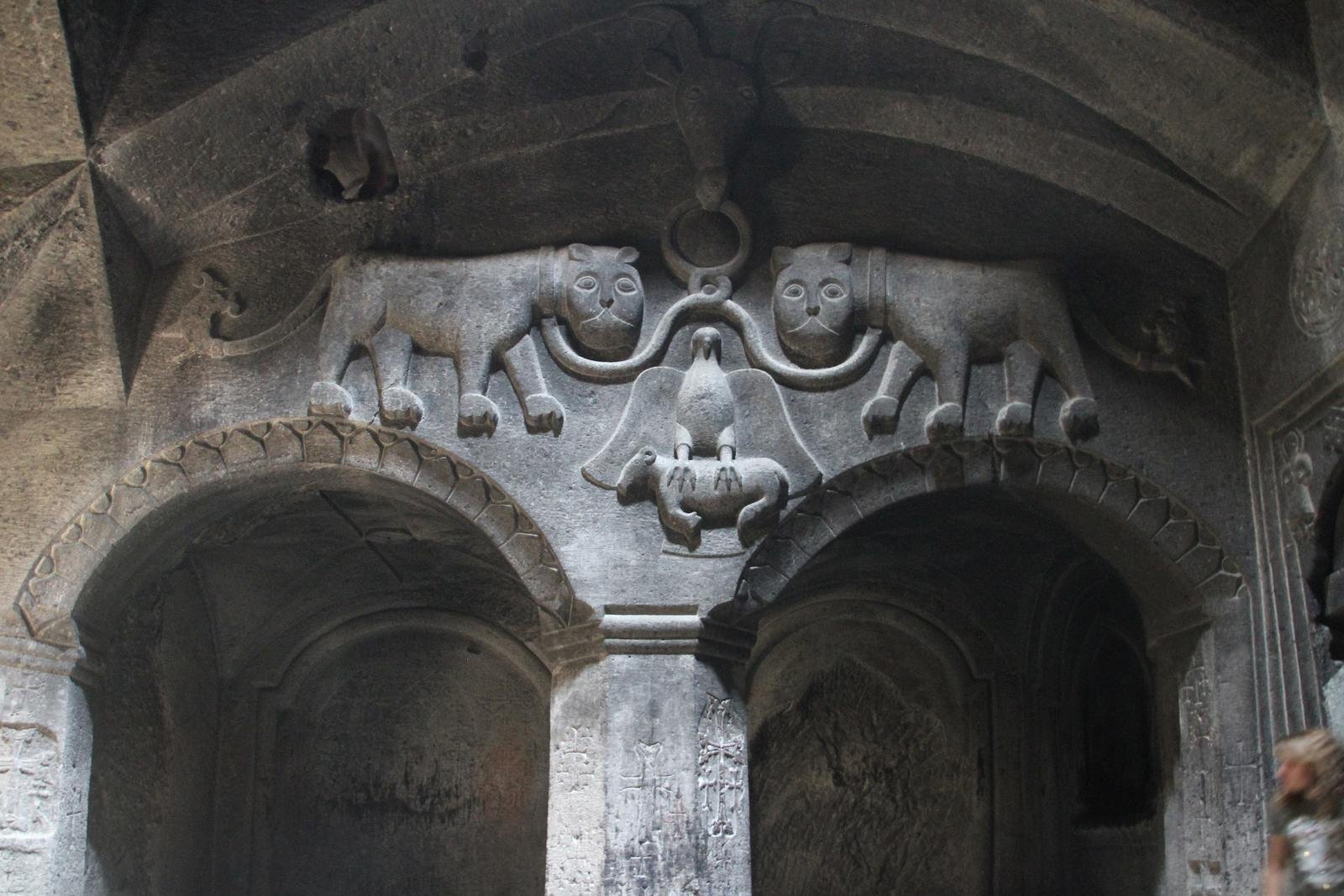 The Proshyan coat of arms carved into the rock wall at Geghard Monastery