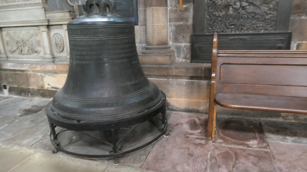 The old great bell of Glasgow Cathedral standing on the floor of the church