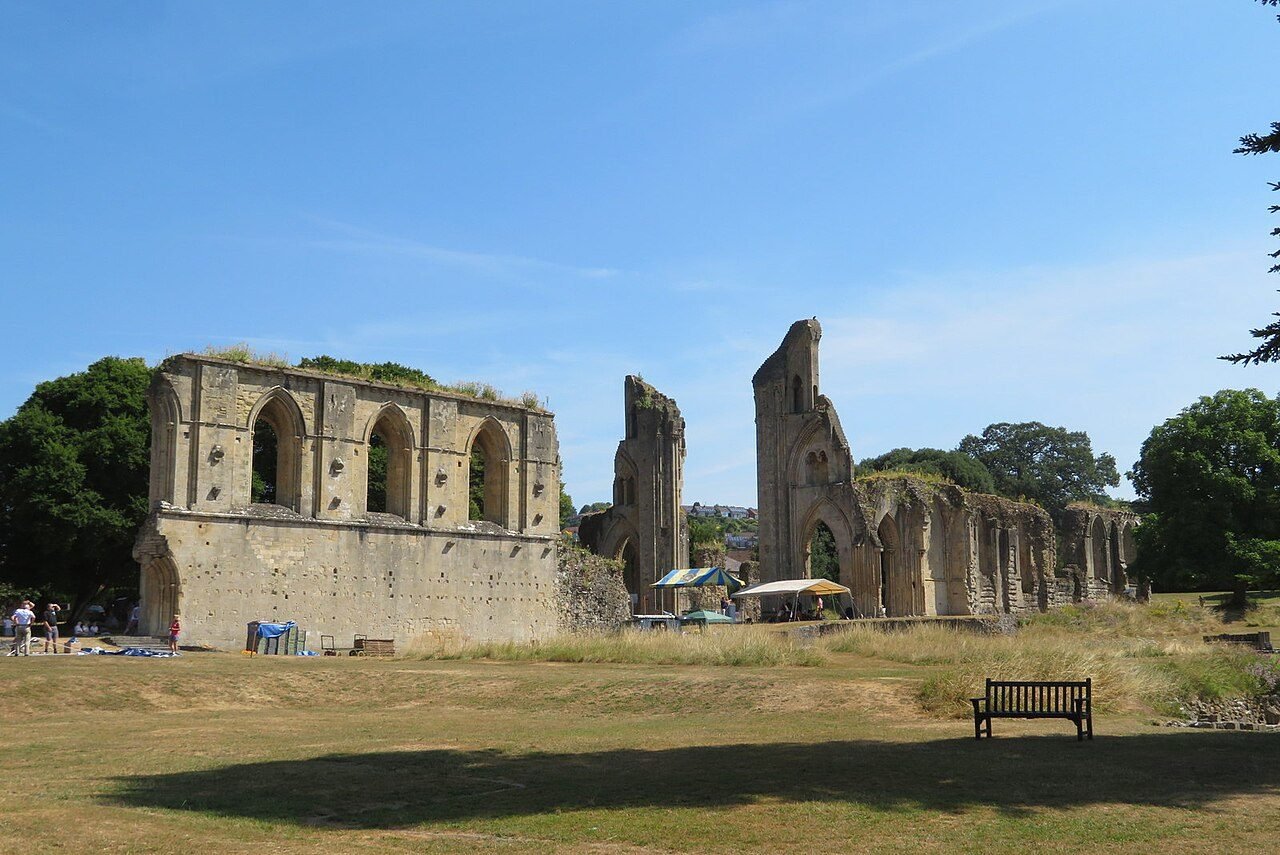 The parkland grounds of Glastonbury Abbey with ruins among the trees