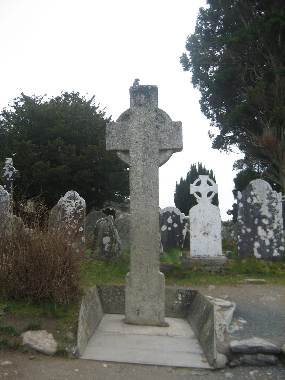 The plain granite high cross known as St Kevin's Cross in the graveyard at Glendalough