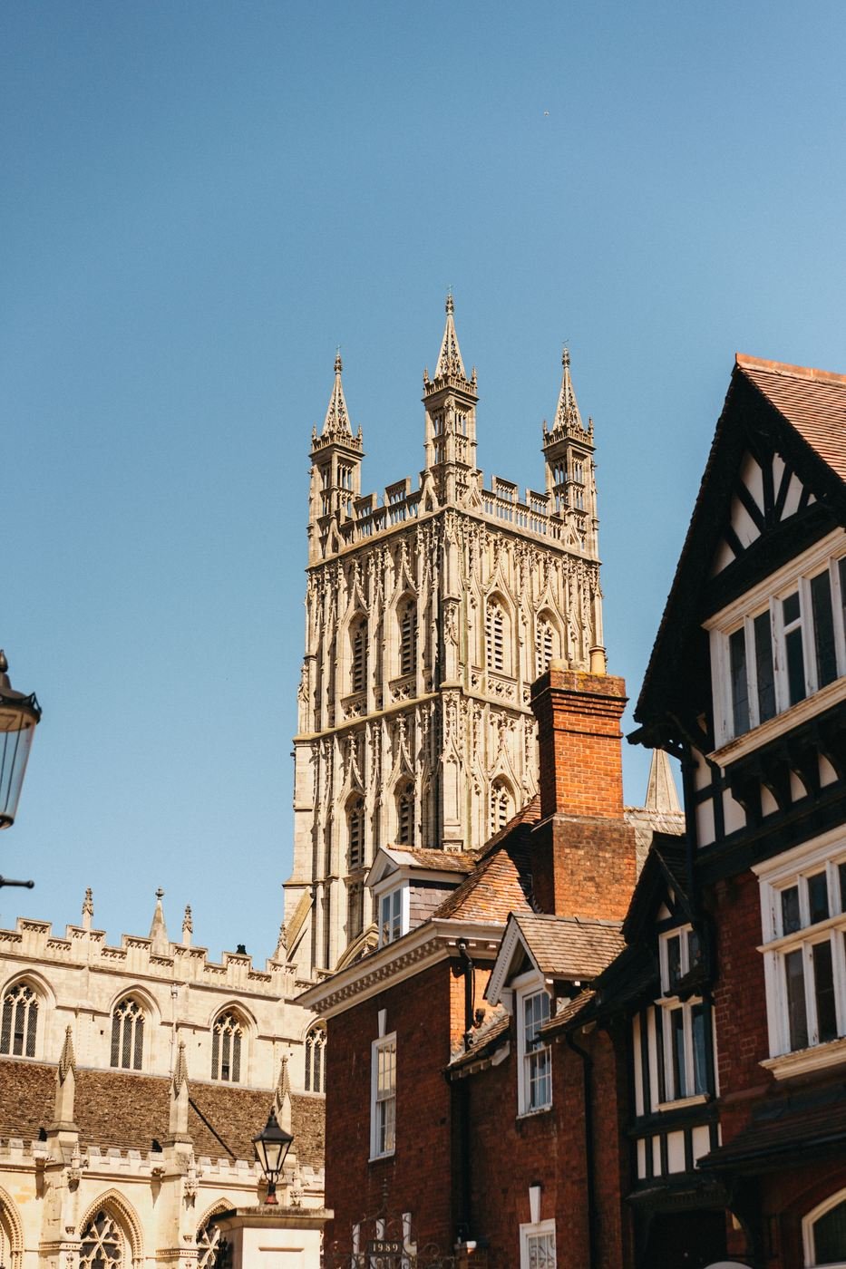 The tower of Gloucester Cathedral seen above the rooftops of the old city