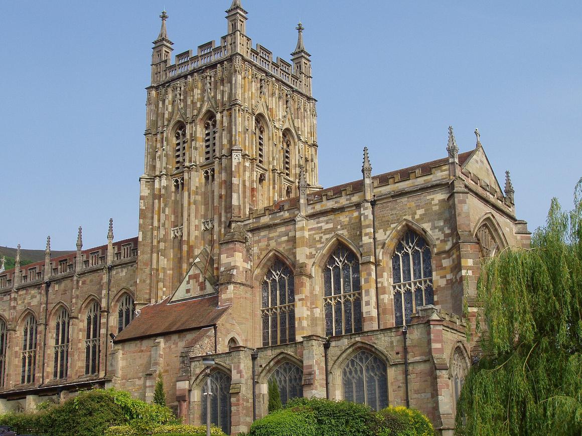 Great Malvern Priory with its tall pinnacled central tower and Perpendicular windows