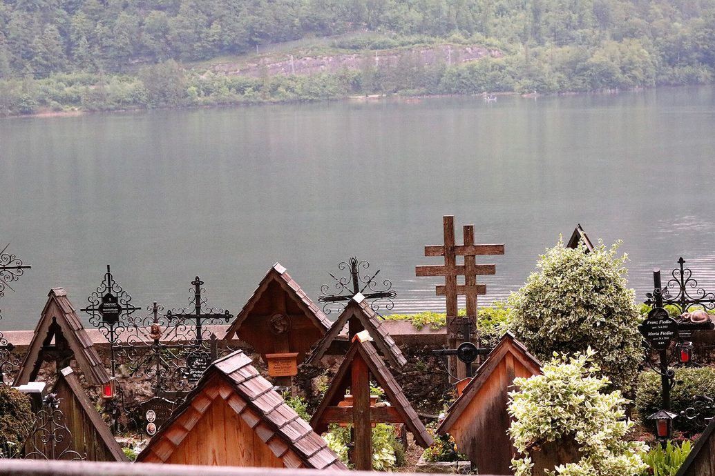 The small terraced cemetery of Hallstatt with wooden and iron grave crosses and flowers
