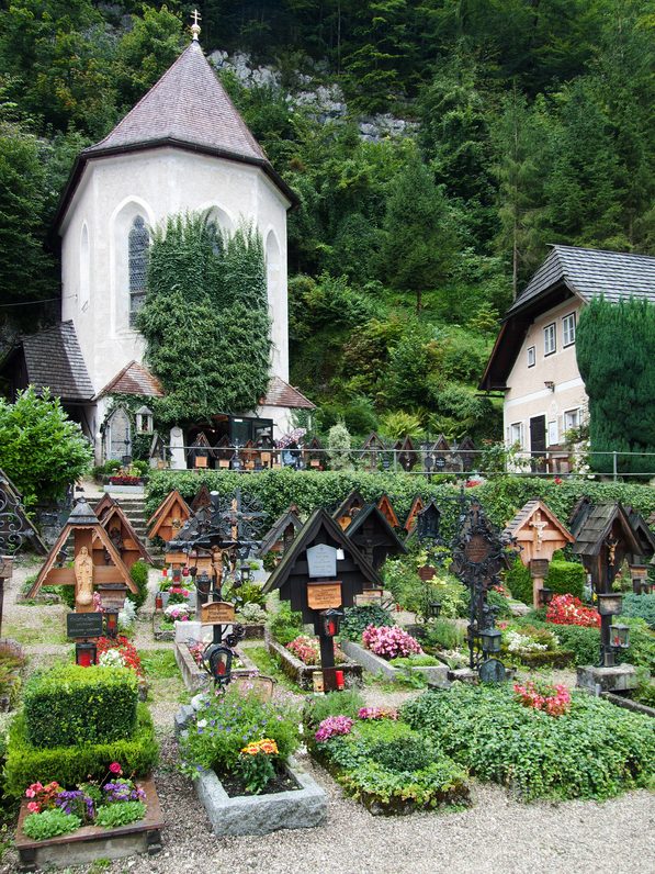 St Michael's Chapel, which houses the charnel house, among the graves of the cemetery in Hallstatt