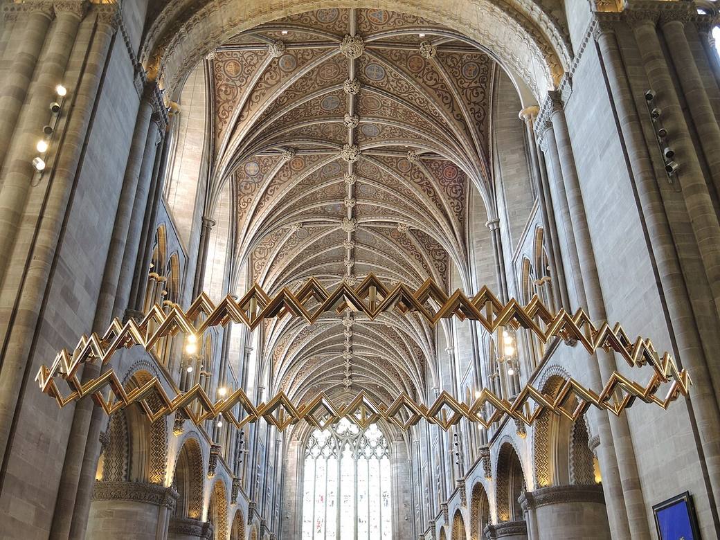 A large suspended crown-shaped corona hanging in Hereford Cathedral