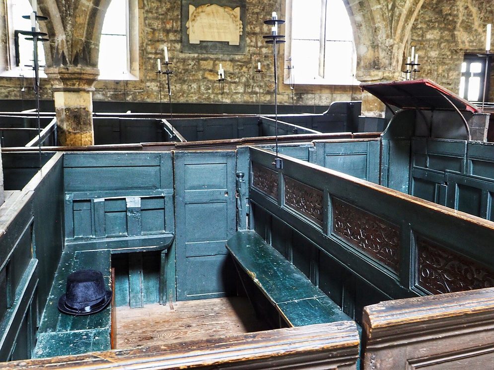 Close view of painted box pews with doors and high panelled sides in Holy Trinity, Goodramgate