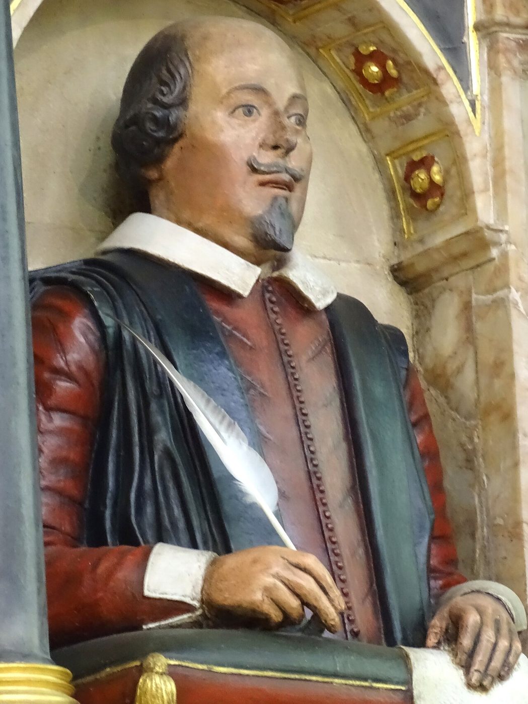 The painted funerary monument of William Shakespeare, a half-length bust holding a quill, in Holy Trinity Church