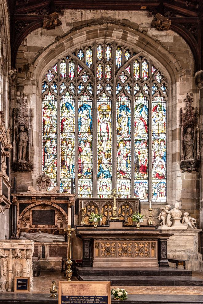 The chancel of Holy Trinity, Stratford, with the great stained-glass east window above the altar