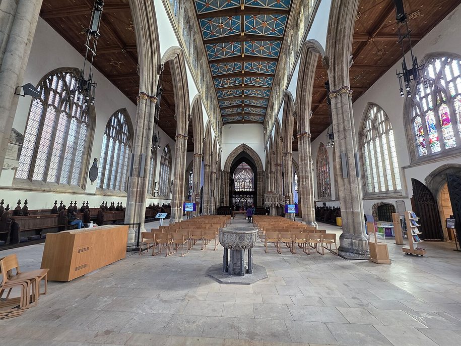 The open west end of the nave at Hull Minster with the medieval font and the floor slabs