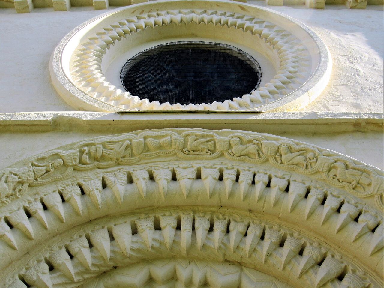 Close view of the beakhead carvings around the west doorway arch at Iffley church