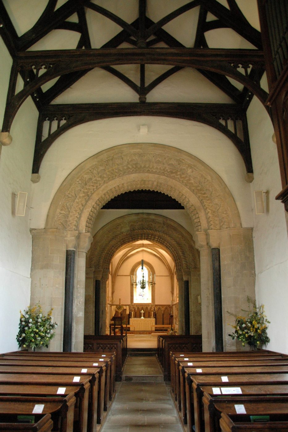 Looking east through the Norman arches of the tower to the chancel at Iffley church