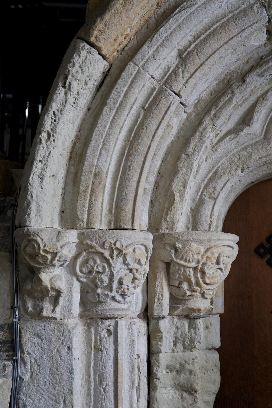 Carved medieval stone capitals and an arch inside Iona Abbey church