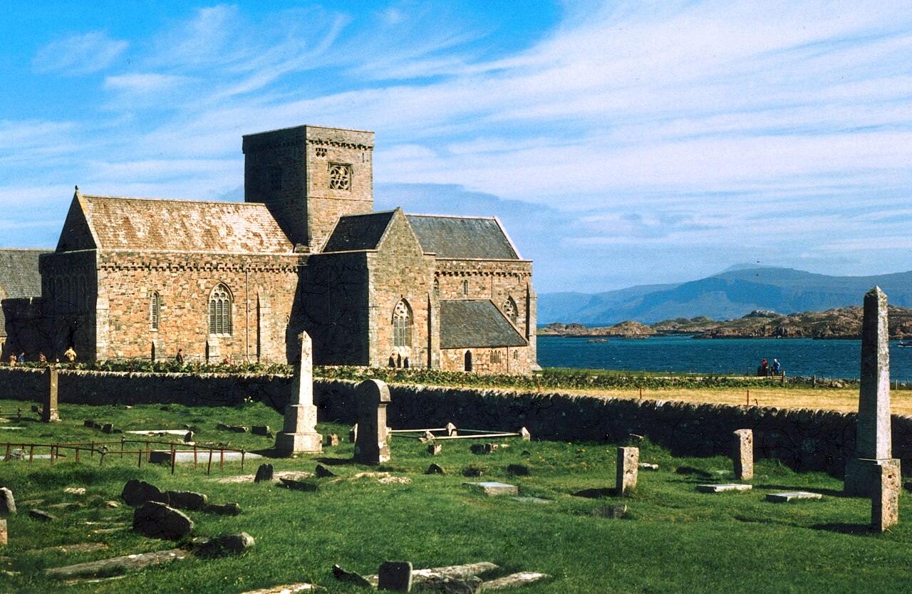 Gravestones in front of Iona Abbey with the hills of Mull across the water