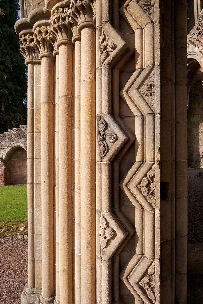 Carved Romanesque shafts and zigzag mouldings in the sandstone at Jedburgh Abbey