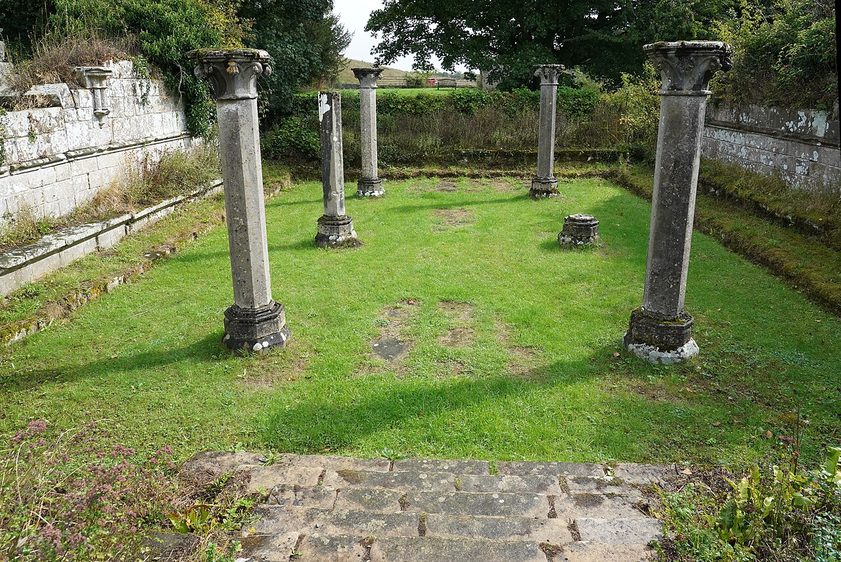 The slender stone columns that once held up the vault of the chapter house at Jervaulx Abbey, on a lawn