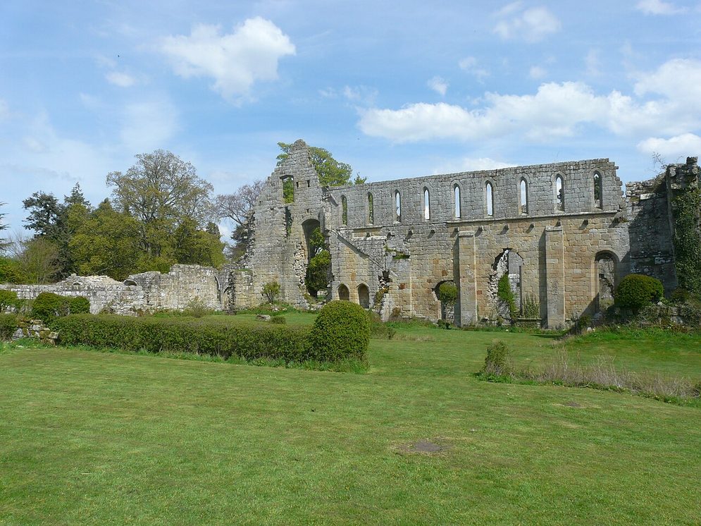The tall west wall of the dormitory range at Jervaulx Abbey, pierced by a regular row of lancet windows