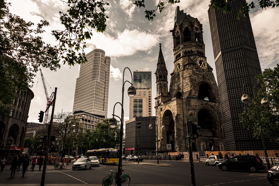The broken tower of the Kaiser Wilhelm Memorial Church among modern office towers on Breitscheidplatz, Berlin