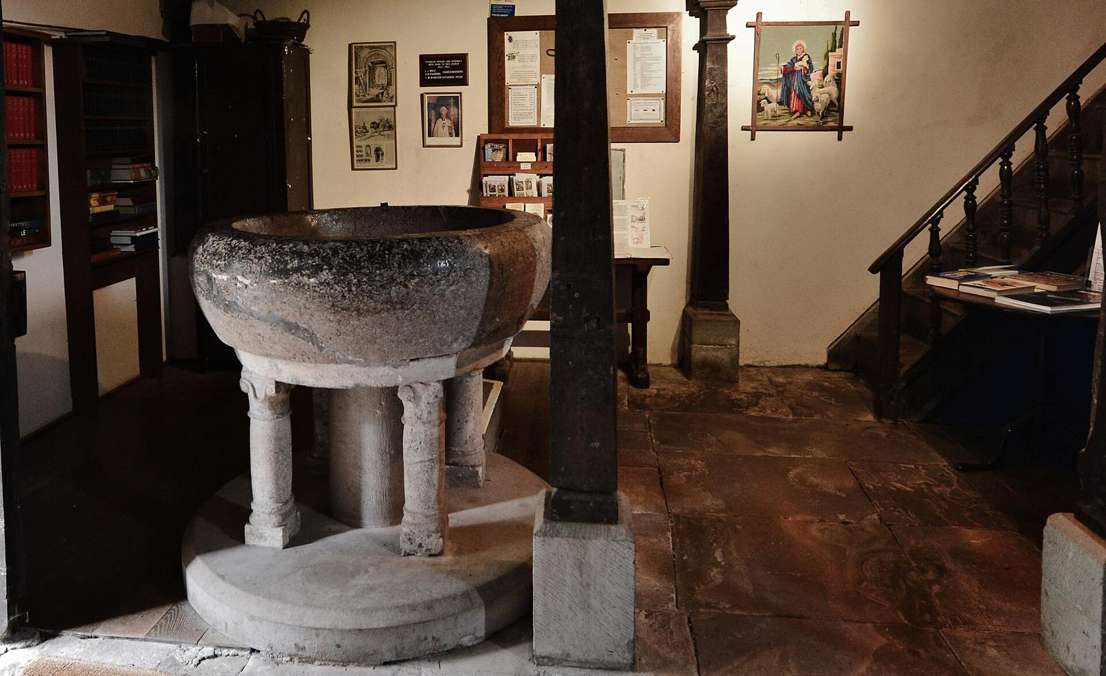 The huge plain round font of conglomerate stone at Kilpeck church