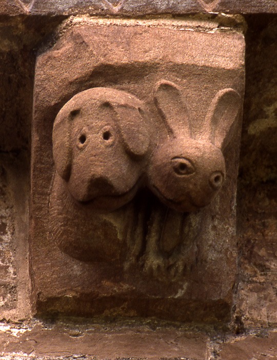A carved corbel at Kilpeck showing a hound and a hare