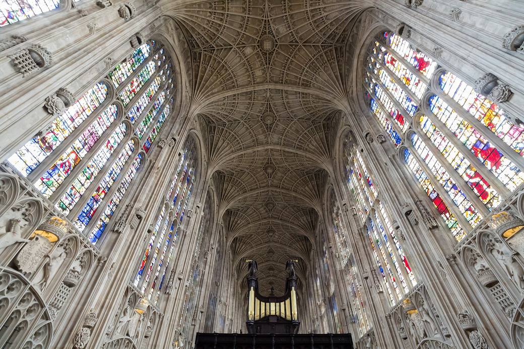 The fan vault of King's College Chapel spreading across the ceiling between the tall windows