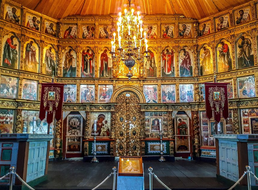 A gilded iconostasis and chandelier inside one of the churches of the Kizhi Pogost