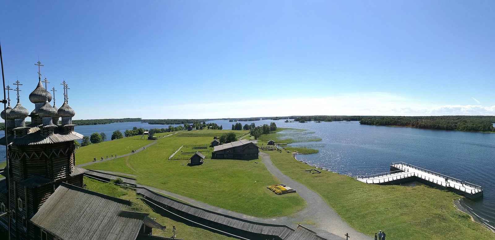 Panoramic view from the Kizhi bell tower over the island's meadows, the boat pier and Lake Onega