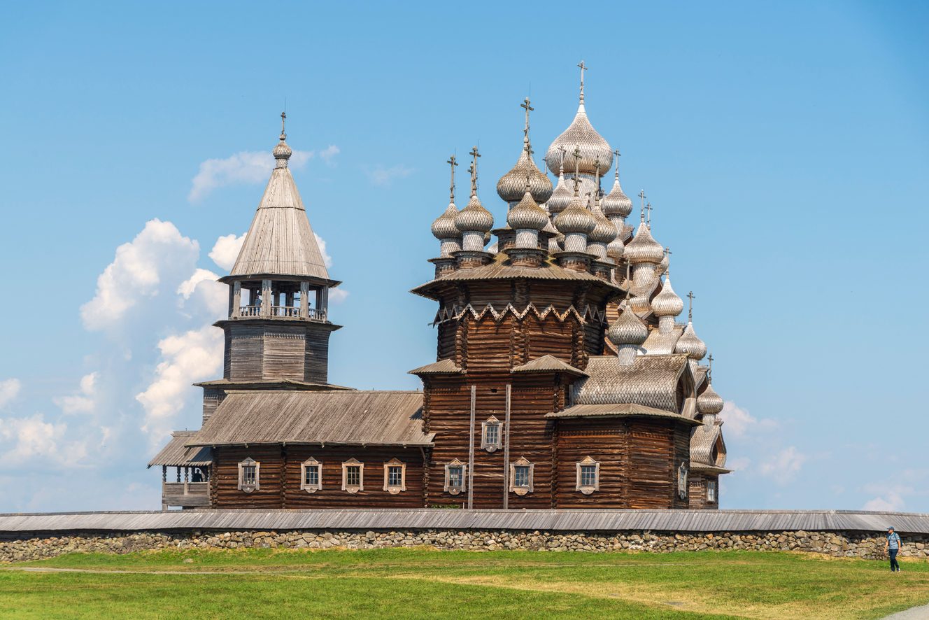The wooden Church of the Transfiguration on Kizhi Island with its pyramid of silver-grey domes, beside the bell tower and the smaller Church of the Intercession